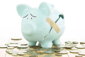 Image of a broken piggy bank that's been taped back together to represent the impact that health insurance costs have on Americans.