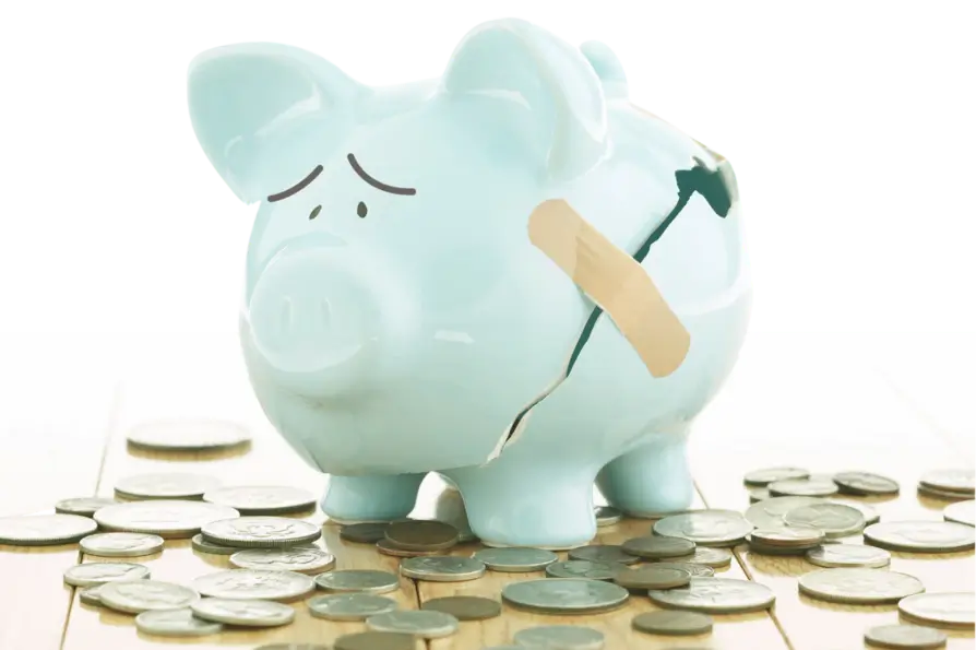 Image of a broken piggy bank that's been taped back together to represent the impact that health insurance costs have on Americans.